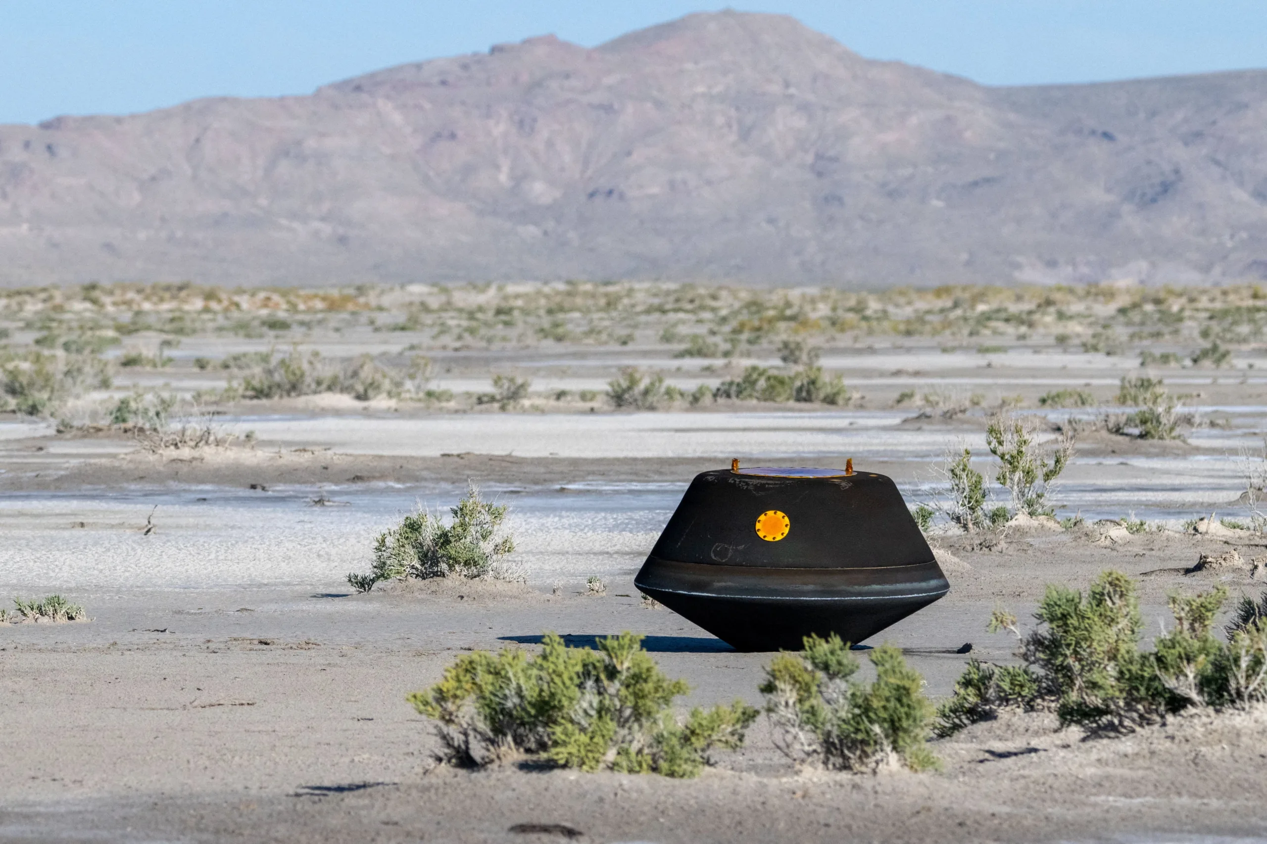 The return capsule containing a sample collected from the asteroid Bennu in October 2020 by NASA’s OSIRIS-REx spacecraft is seen shortly after touching down in the desert at the Department of Defense's Utah Test and Training Range in Dugway, Utah, U.S. September 24, 2023. NASA/Keegan Barber/Handout via REUTERS