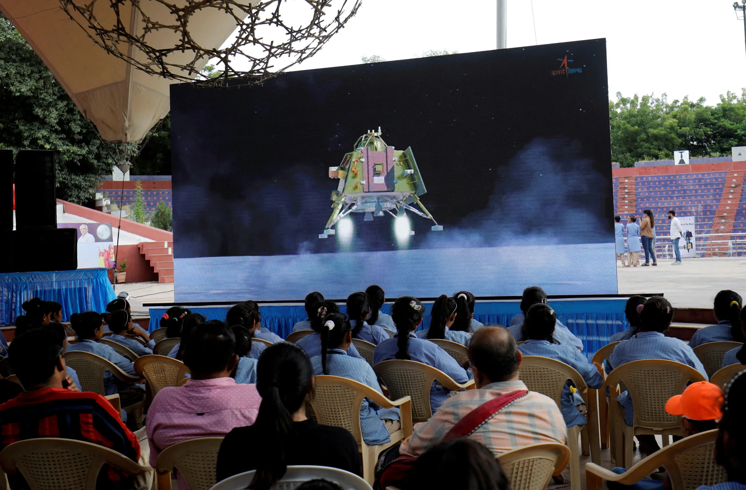 FILE PHOTO: People watch a live stream of Chandrayaan-3 spacecraft's landing on the moon, inside an auditorium of Gujarat Science City in Ahmedabad, India, August 23, 2023. REUTERS/Amit Dave/File Photo