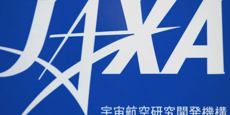 FILE PHOTO: A logo of Japan Aerospace Exploration Agency (JAXA) is seen in front of a gate at the JAXA Chofu Aerospace Center Aerodrome Branch in Tokyo January 22, 2013. REUTERS/Issei Kato