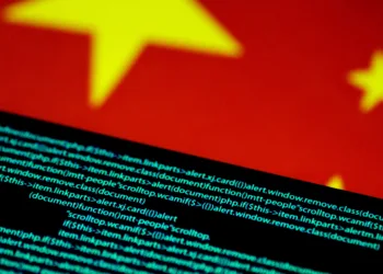 FILE PHOTO: Computer code is seen on a screen above a Chinese flag in this July 12, 2017 illustration photo.   REUTERS/Thomas White/Illustration/File Photo