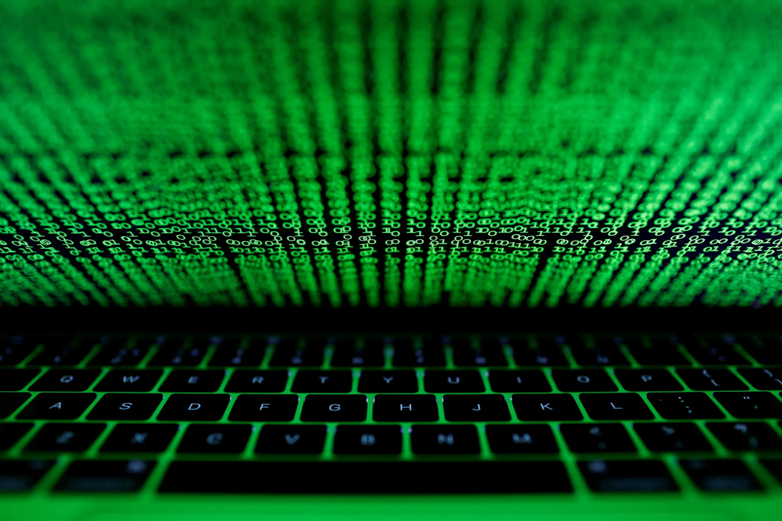 FILE PHOTO: A computer keyboard lit by a displayed cyber code is seen in this illustration picture taken on March 1, 2017. REUTERS/Kacper Pempel/Illustration