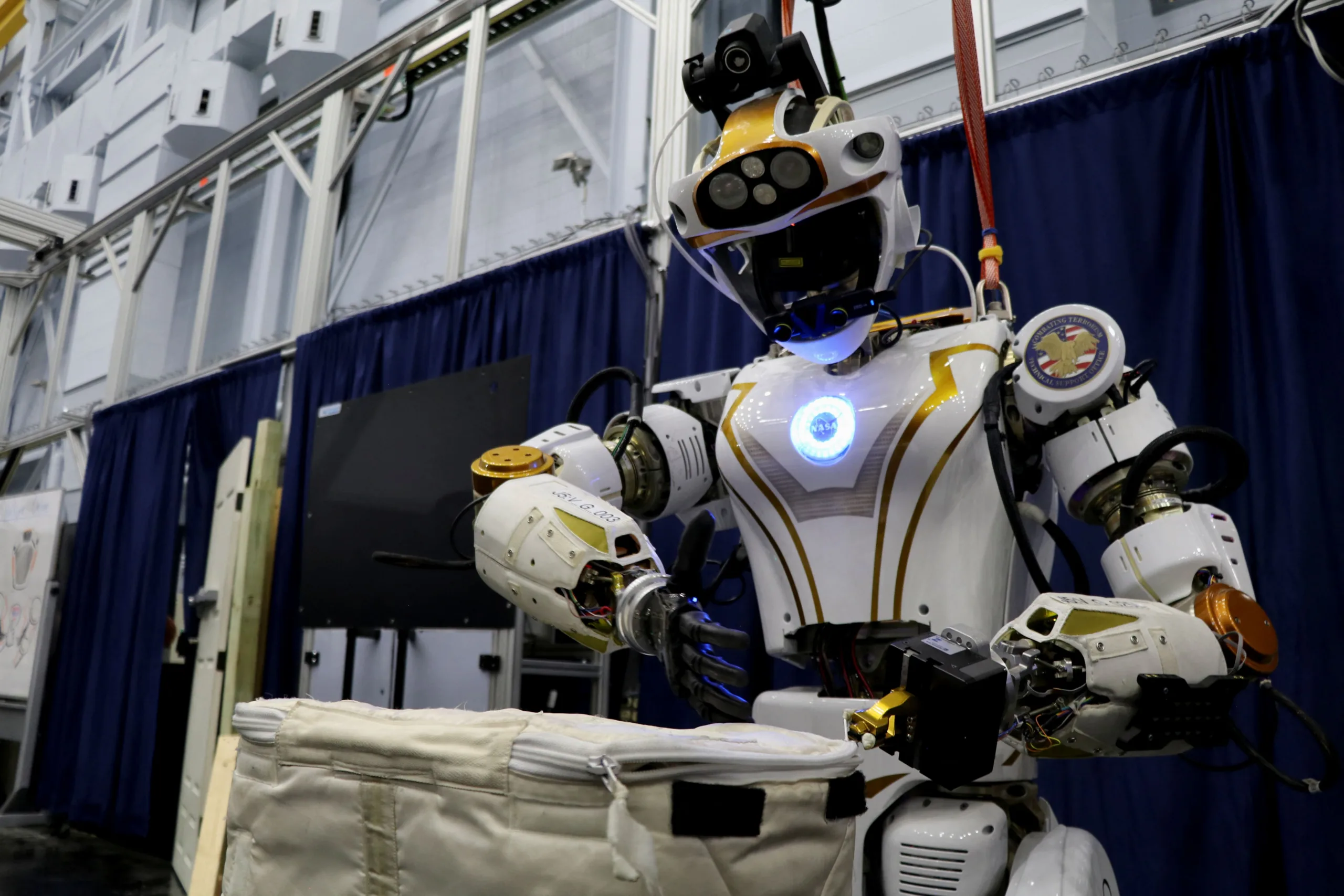 NASA's humanoid robot Valkyrie opens a bag at the Johnson Space Center in Houston, Texas, U.S., November 16, 2023. REUTERS/Evan Garcia