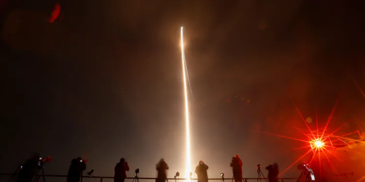 People take photographs during the launch of Boeing-Lockheed joint venture United Launch Alliance's next-generation Vulcan rocket on its debut flight from Cape Canaveral, Florida, U.S. January 8, 2024. REUTERS/Joe Skipper