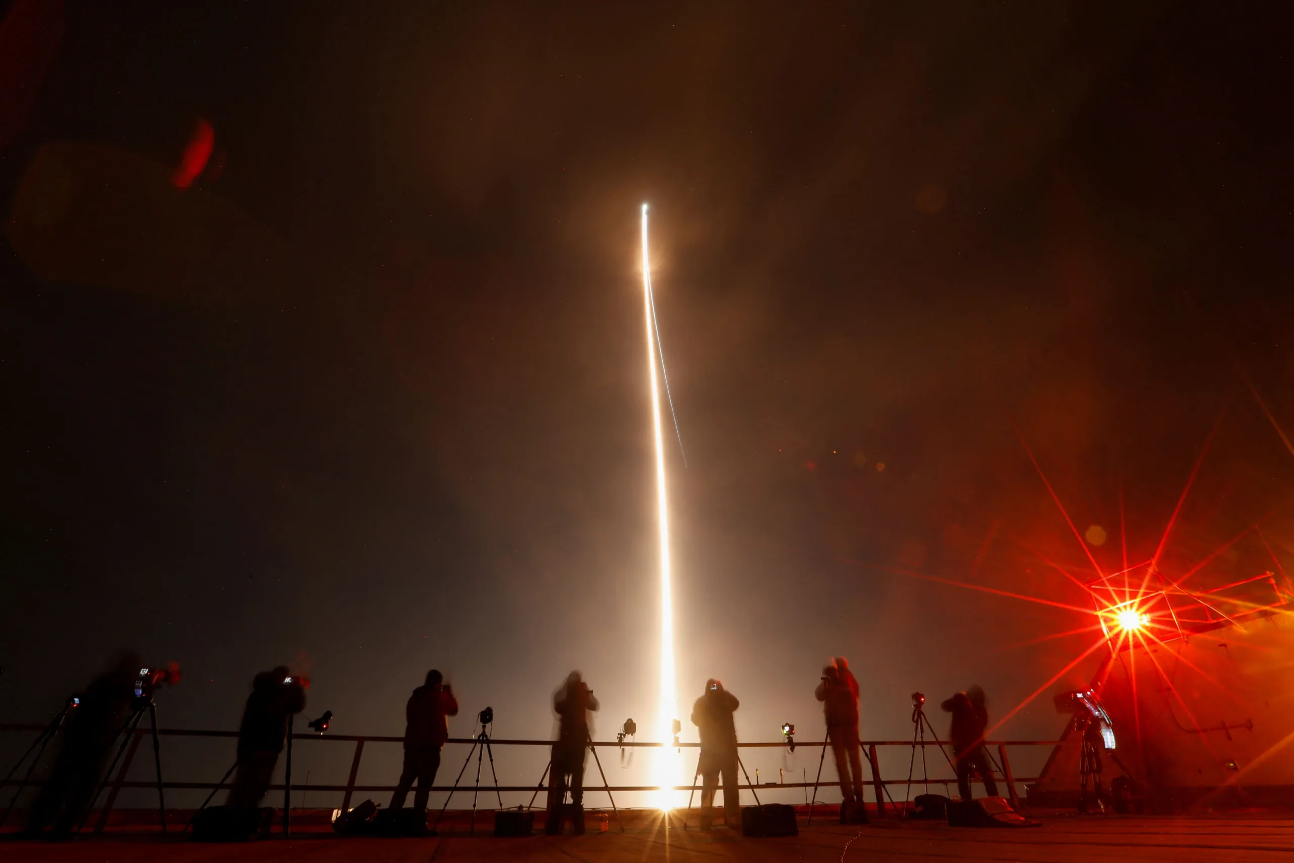 People take photographs during the launch of Boeing-Lockheed joint venture United Launch Alliance's next-generation Vulcan rocket on its debut flight from Cape Canaveral, Florida, U.S. January 8, 2024. REUTERS/Joe Skipper