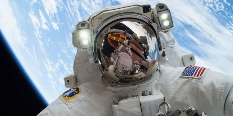 FILE PHOTO: An astronaut is shown in this handout photo provided by NASA participating in a spacewalk that took place on December 24, 2013, released on December 27, 2013. REUTERS/NASA/Handout via Reuters/File Photo