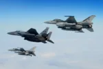 An U.S. Air Force F-15E Strike Eagle, Royal Netherlands Air Force F-16 (top) and Belgian Component F-16 (bottom) conduct aerial operations over the North Sea, July 17, 2020. Interoperability and collective readiness, deter potential adversaries and ensure the skies within the European theater remain sovereign. (U.S. Air Force photo by Master Sgt. Matthew Plew)