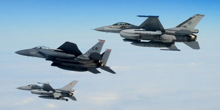 An U.S. Air Force F-15E Strike Eagle, Royal Netherlands Air Force F-16 (top) and Belgian Component F-16 (bottom) conduct aerial operations over the North Sea, July 17, 2020. Interoperability and collective readiness, deter potential adversaries and ensure the skies within the European theater remain sovereign. (U.S. Air Force photo by Master Sgt. Matthew Plew)
