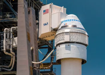 Close-up of the Boeing CST-100 Starliner capsule, white room attached, atop the mighty Atlas V launch vehicle at Cape Canaveral's SLC-41.