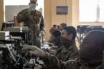 Soldiers in advanced individual training on Fort Sill learn about the single channel ground and airborne radio system on Fort Sill, Okla., April 21, 2020.  Students and instructors are required to wear face masks.