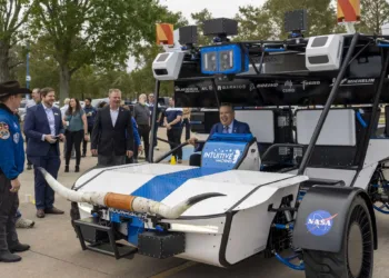 Intuitive Machines Senior Vice President of Space Systems Trent Martin, left center, stands near as Space Center Houston President and CEO William Harris, right, smiles as he sits in the seat of the Intuitive Machines Moonracer Lunar Terrain Vehicle (LTV) during a reveal of the vehicle Thursday, Nov. 7, 2024 in Houston.