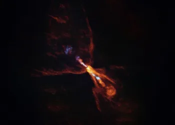 This is HOPS-315, a baby star where astronomers have observed evidence for the earliest stages of planet formation. The image was taken with the Atacama Large Millimeter/submillimeter Array (ALMA), in which ESO is a partner. Together with data from the James Webb Space Telescope (JWST), these observations show that hot minerals are beginning to solidify. In orange we see the distribution of carbon monoxide, blowing away from the star in a butterfly-shaped wind. In blue we see a narrow jet of silicon monoxide, also beaming away from the star. These gaseous winds and jets are common around baby stars like HOPS-315. Together the ALMA and JWST observations indicate that, in addition to these features, there is also a disc of gaseous silicon monoxide around the star that is condensing into solid silicates –– the first stages of planetary formation.