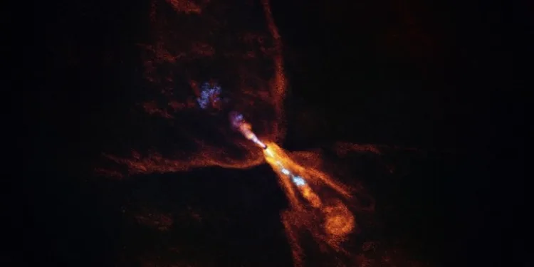This is HOPS-315, a baby star where astronomers have observed evidence for the earliest stages of planet formation. The image was taken with the Atacama Large Millimeter/submillimeter Array (ALMA), in which ESO is a partner. Together with data from the James Webb Space Telescope (JWST), these observations show that hot minerals are beginning to solidify. In orange we see the distribution of carbon monoxide, blowing away from the star in a butterfly-shaped wind. In blue we see a narrow jet of silicon monoxide, also beaming away from the star. These gaseous winds and jets are common around baby stars like HOPS-315. Together the ALMA and JWST observations indicate that, in addition to these features, there is also a disc of gaseous silicon monoxide around the star that is condensing into solid silicates –– the first stages of planetary formation.
