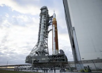 El cohete del Sistema de Lanzamiento Espacial (SLS) Artemis II de la NASA y la nave espacial Orion, asegurados a la plataforma móvil, se observan mientras realizan el viaje de 4,2 millas hacia la Plataforma de Lanzamiento 39B, el sábado. Crédito de la foto: (NASA/Keegan Barber)