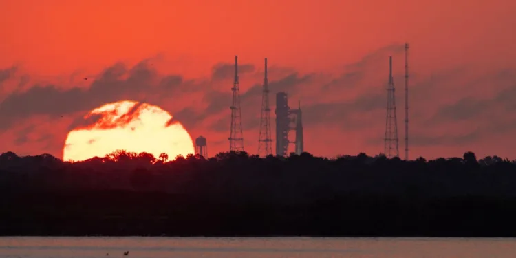 El sol sale detrás del cohete Space Launch System (SLS) de la NASA en el Complejo de Lanzamiento 39B del Centro Espacial Kennedy.